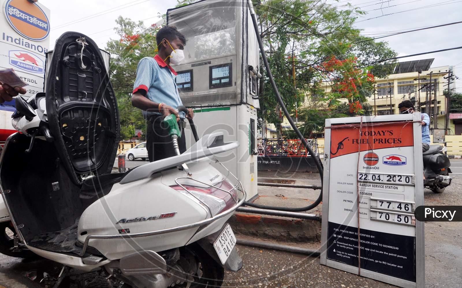 A Worker Re-filling a scooty At A Petrol Station During A Nationwide Lockdown Amidst COVID-19 or Coronavirus Outbreak  In Guwahati On April 22, 2020