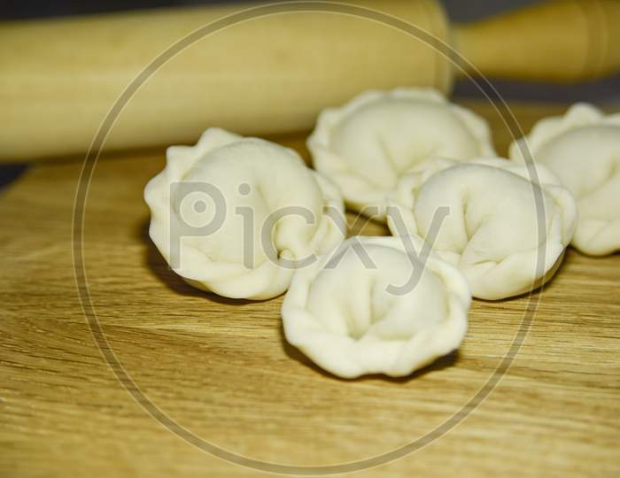 Five Dumplings Of Round Shape On The Wooden Deck. Selective Focus. Close-Up Look.