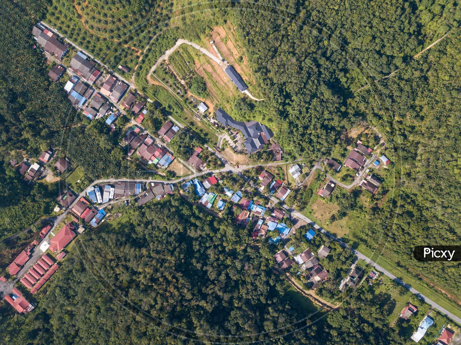 Aerial View Look Down Kampung Baru Bukit Besar Housing Estate Near Plantation Farm.