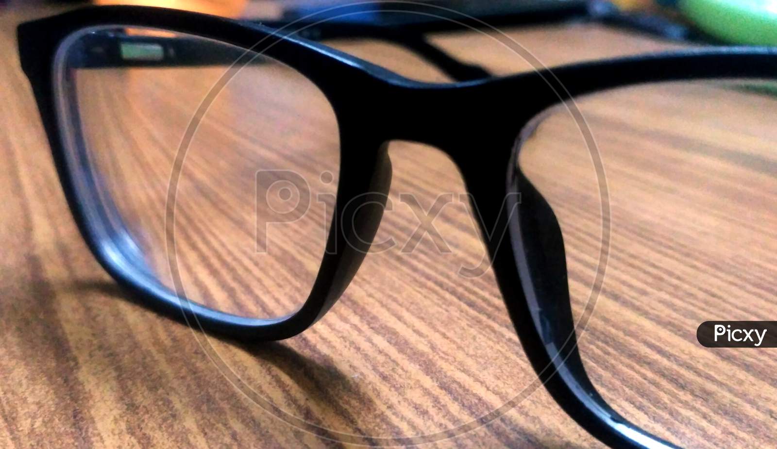 Glasses In Black Vintage Frame On Wooden Background, Table. View From Above.