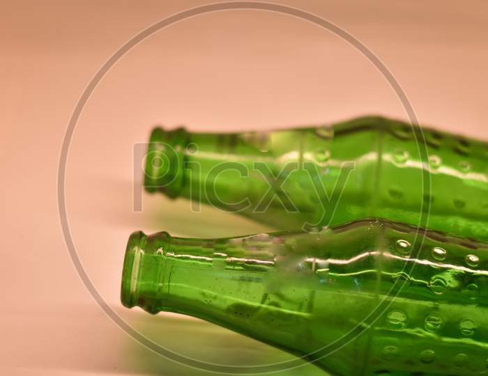 closeup of a green cold drink bottle with white background