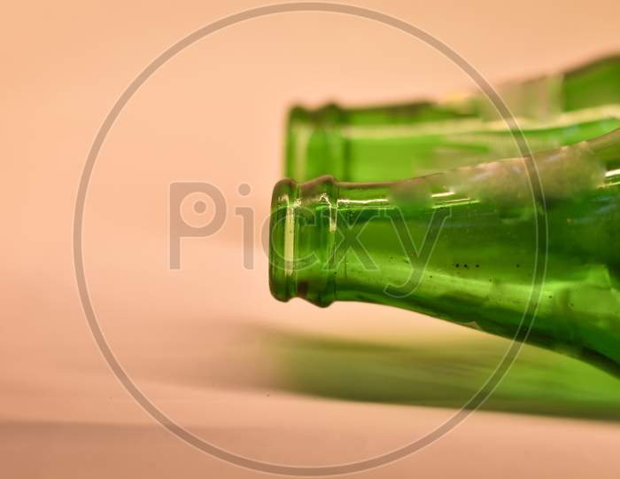 closeup of a green cold drink bottle with white background