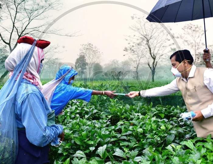 Assam Chief Minister Sarbananda Sonowal Distributing Face Mask Among The Tea Tribe Workers  During Nationwide Lockdown Amidst Coronavirus or COVID-19  Outbreak  in Dibrugarh District Of Assam On April 24,2020.