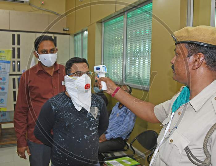 Thermal screening of the visitors during the ongoing Novel Coronavirus (COVID-19) pandemic at the district magistrate's office in Purba Bardhaman District.