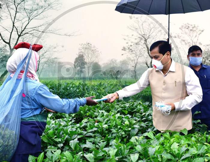 Assam Chief Minister Sarbananda Sonowal Distributing Face Mask Among The Tea Tribe Workers  During Nationwide Lockdown Amidst Coronavirus or COVID-19  Outbreak  in Dibrugarh District Of Assam On April 24,2020.