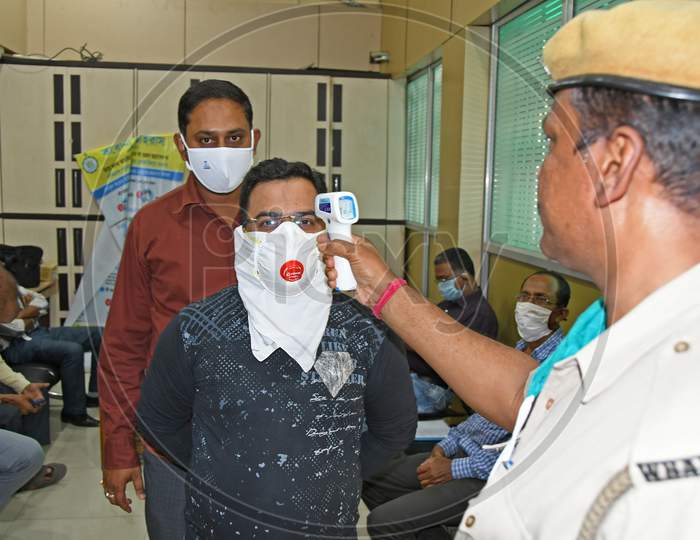 Thermal screening of the visitors during the ongoing Novel Coronavirus (COVID-19) pandemic at the district magistrate's office in Purba Bardhaman District.