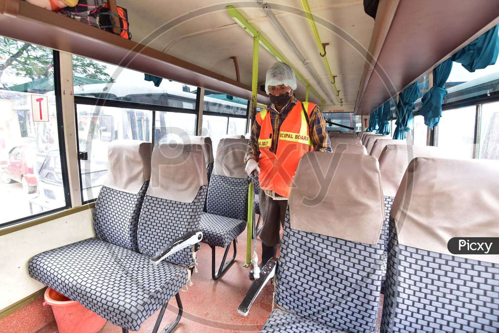 Municipal Workers Sanitizing Buses During nationwide Lockdown Amidst Coronavirus or COVID-19 Outbreak in Nagaon, Assam April 25 2020