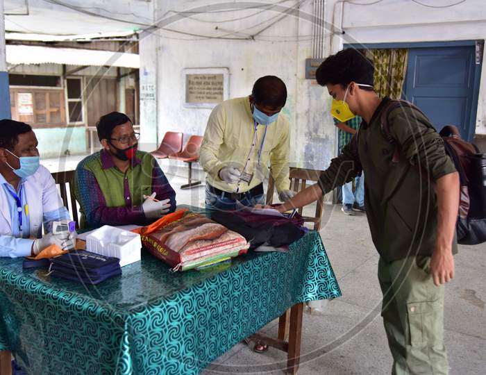 Doctors Stamping the Passengers Hands After Medical Examinations At A.S.T.C Bus stand During a Nationwide Lockdown Amidst Coronavirus Or COVID-19 Outbreak in Nagaon, Assam , April 25 2020