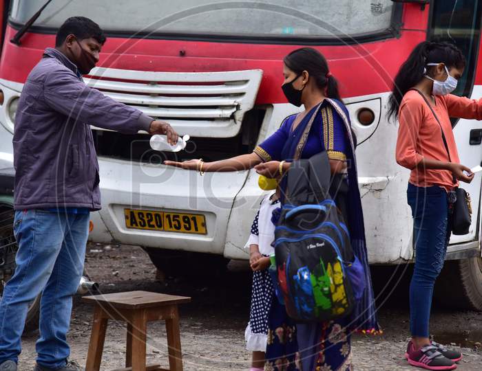Passengers Sanitizing Hands Before Boarding Buses At A.S.T.C Bus Stand During Nationwide Lockdown Amidst Coronavirus or COVID-19 Outbreak in nagaon, Assam April 25 2020