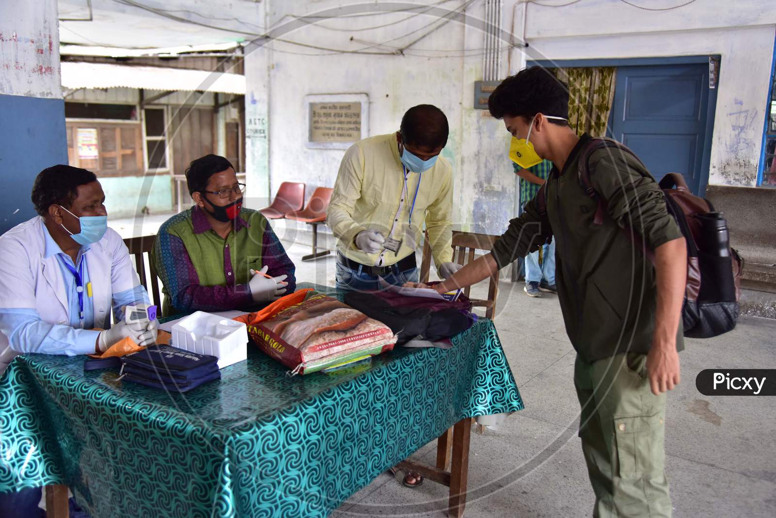 Doctors Stamping the Passengers Hands After Medical Examinations At A.S.T.C Bus stand During a Nationwide Lockdown Amidst Coronavirus Or COVID-19 Outbreak in Nagaon, Assam , April 25 2020