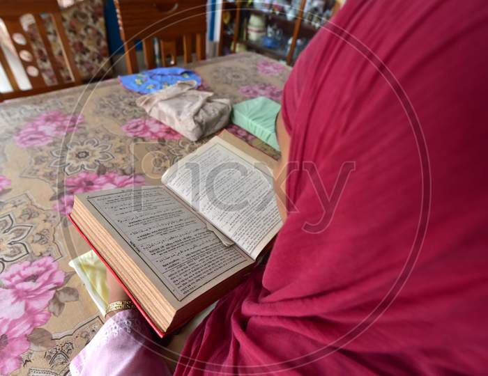 A Muslim Woman Reading The Holy Quran  on the First Day of Ramzan or Ramadan Month in Nagaon, Assam April 25 2020