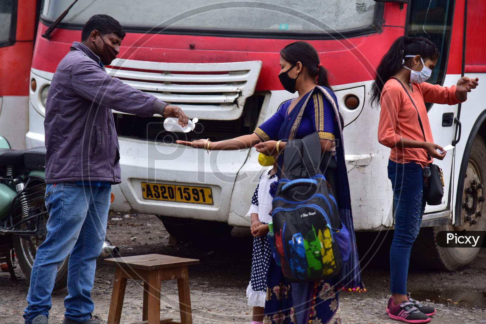 Passengers Sanitizing Hands Before Boarding Buses At A.S.T.C Bus Stand During Nationwide Lockdown Amidst Coronavirus or COVID-19 Outbreak in nagaon, Assam April 25 2020