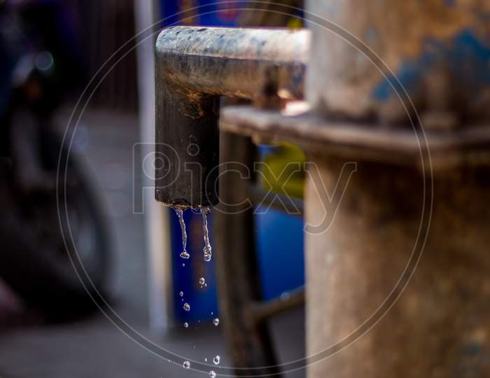 Hand Pump To Pull Under Ground Water In India. Using Manual Water Pump On Street. Water Leaking From Hand Water Pump In India. Save Ground Water.