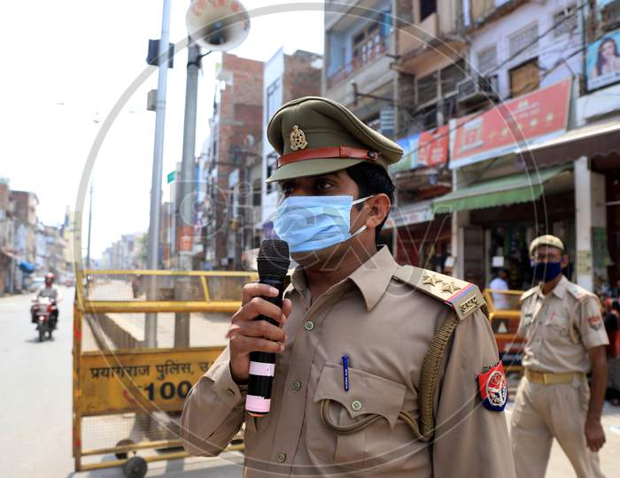 A Policeman Announcing To  Stay In Homes At  a Hot Spot Area  During Nationwide Lockdown Amidst  Coronavirus or COVID-19 Outbreak In Prayagraj, April 25 2020