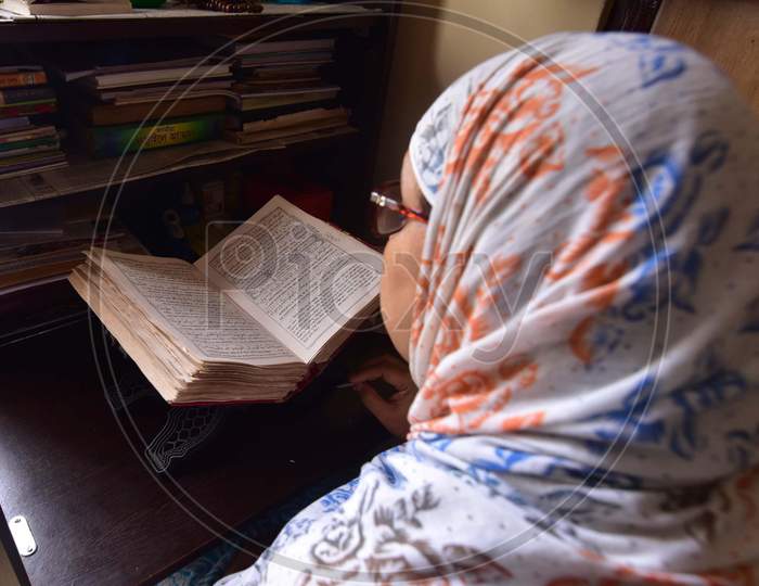 A Muslim Woman Reading The Holy Quran  on the First Day of Ramzan or Ramadan Month in Nagaon, Assam April 25 2020