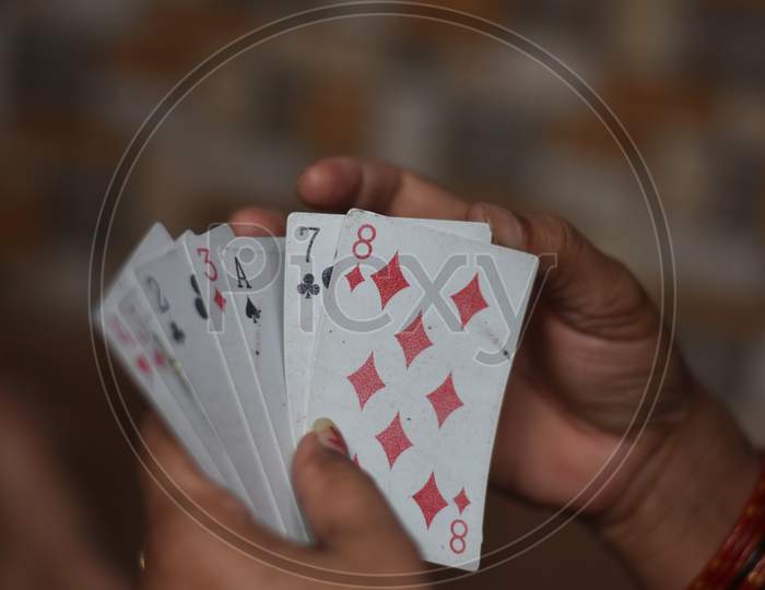 white playing cards in a man hand with blur background