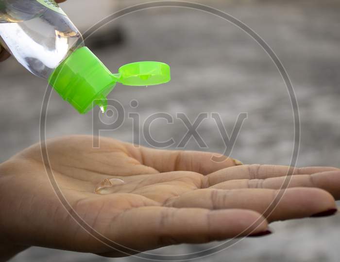 Women Sanitizing Hands With Sanitizer