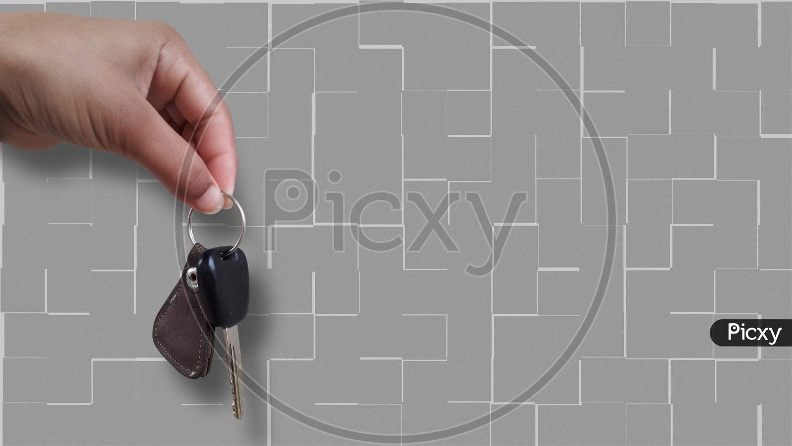 An Asian girl is holding bike key in her hand isolated image in grey textured background