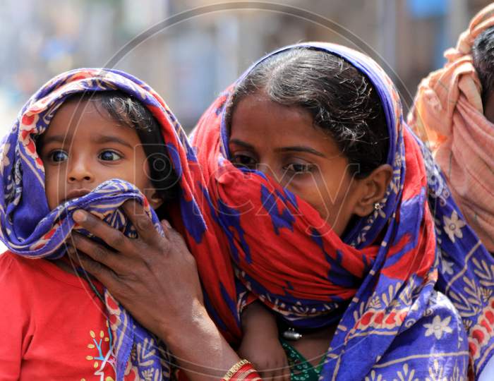 A Mother Covering Her Child Face With Veil during Nationwide Lockdown Amidst Coronavirus or COVID-19 Outbreak In Prayagraj