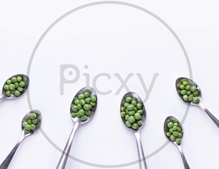Healthy fresh green peas top view flat lay with white background.