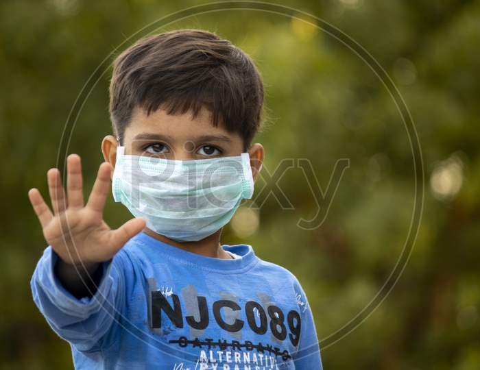 Indian Child With Mask Showing Five Fingers For Do The Five Tips Protecting From Corona Virus