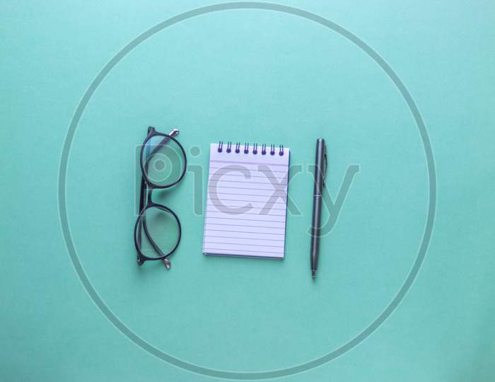 Flat Lay With Notes, Pen and Spectacles On an Isolated Background