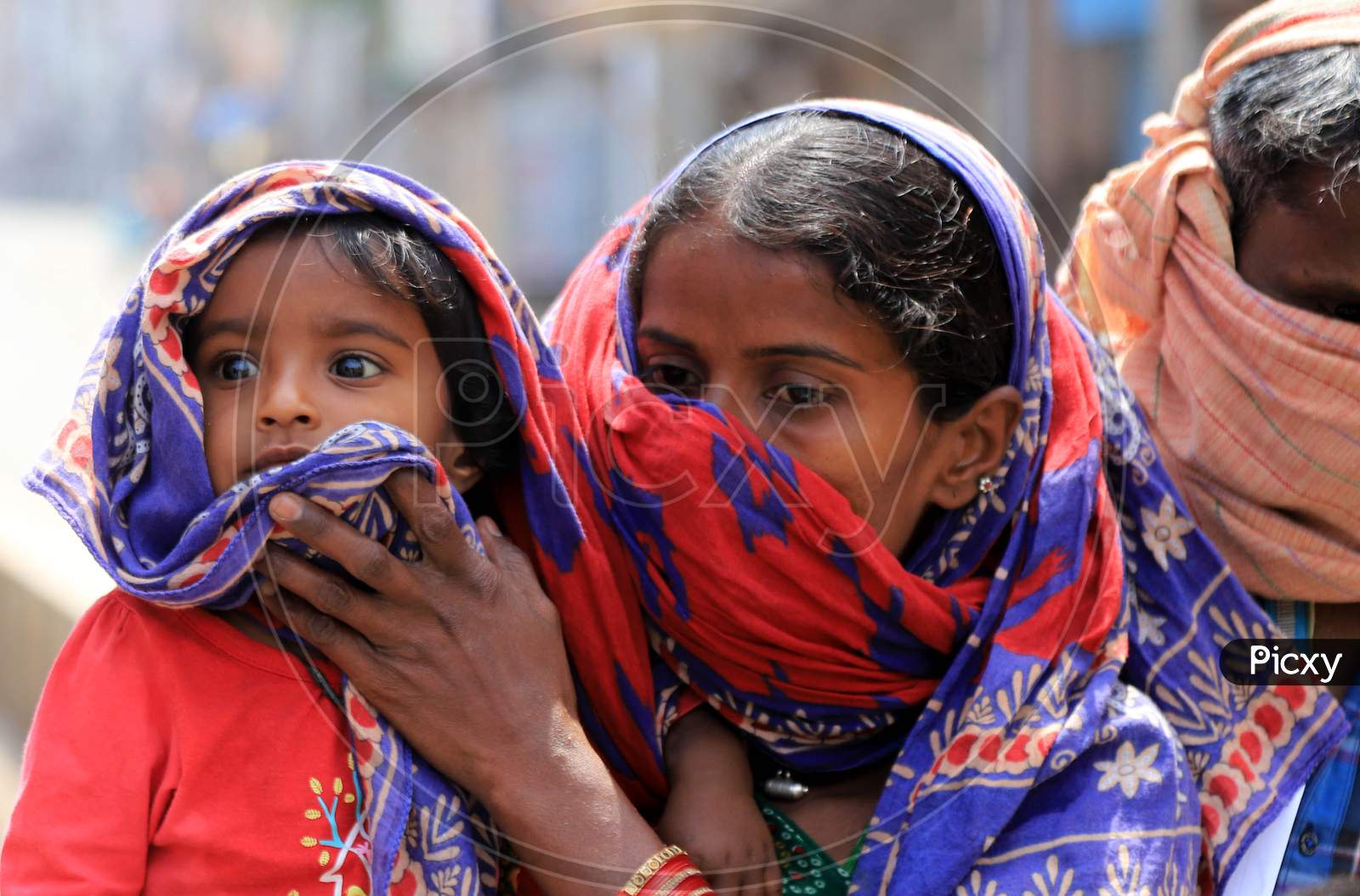 A Mother Covering Her Child Face With Veil during Nationwide Lockdown Amidst Coronavirus or COVID-19 Outbreak In Prayagraj