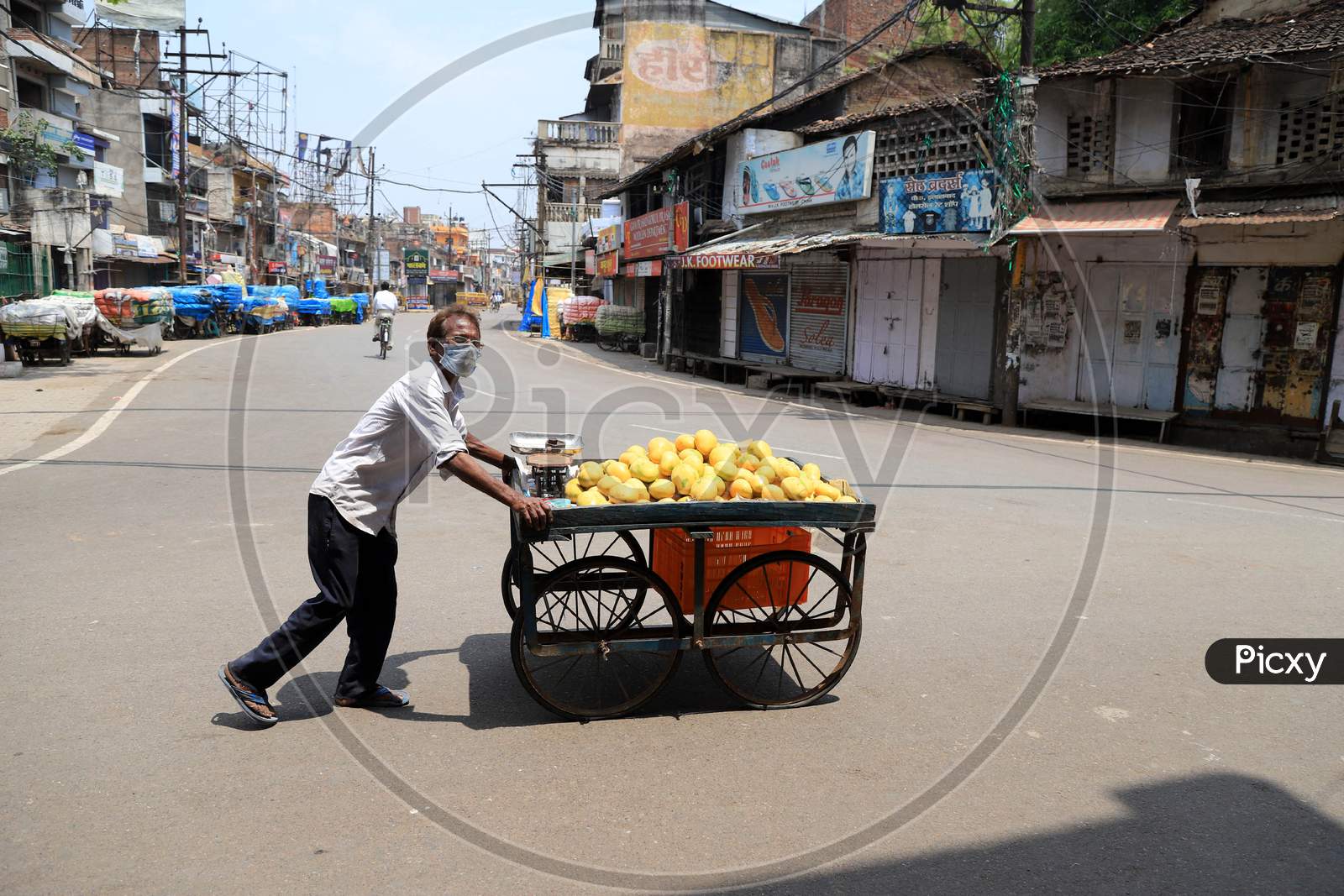 A Vendor Selling Mangoes  On The Empty Road  during Nationwide Lockdown Amidst Coronavirus or COVID-19 Outbreak In Prayagraj