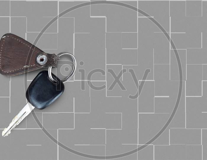 An isolated image of key of bike or motorcycle or scooter with ring in textured grey background