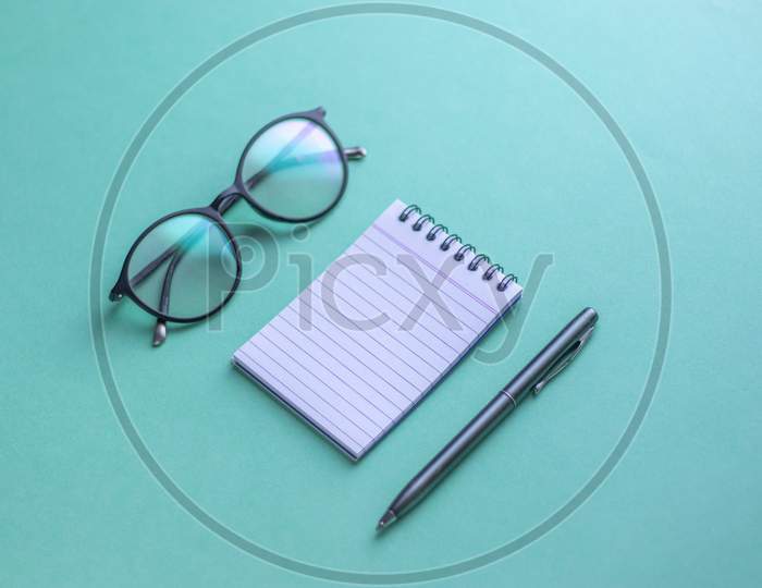 Flat Lay With Notes, Pen an Spectacles On an Isolated Background