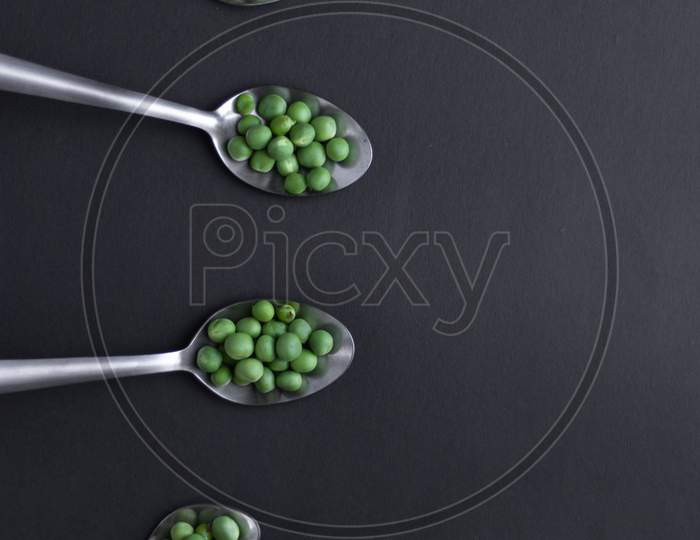 Healthy fresh green peas top view flat lay with black background.