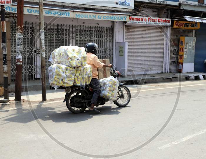 A Vendor Carries  Goods on  Bike On Empty Roads during Nationwide Lockdown Amidst Coronavirus or COVID-19 Outbreak In Prayagraj