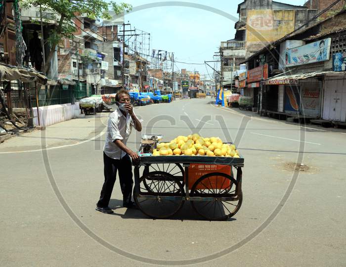 A Vendor Selling Mangoes  On The Empty Road  during Nationwide Lockdown Amidst Coronavirus or COVID-19 Outbreak In Prayagraj