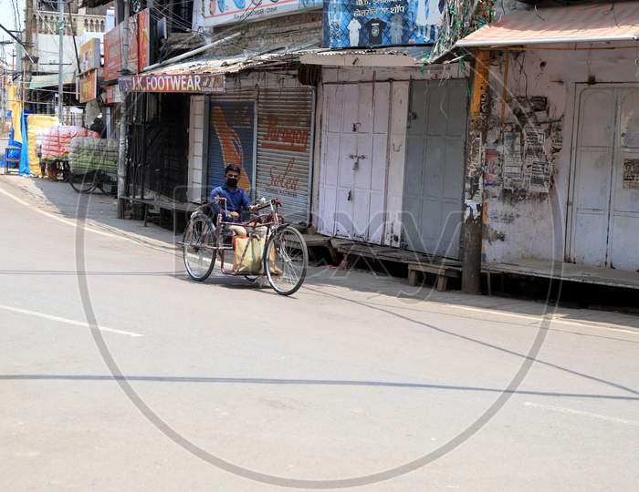 A Man Pedals a Tricycle On Empty Roads During Nationwide Lockdown Amidst Coronavirus Or COVID-19 Pandemic In Prayagraj