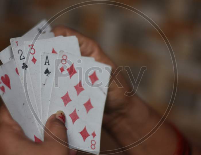 white playing cards in a man hand with blur background