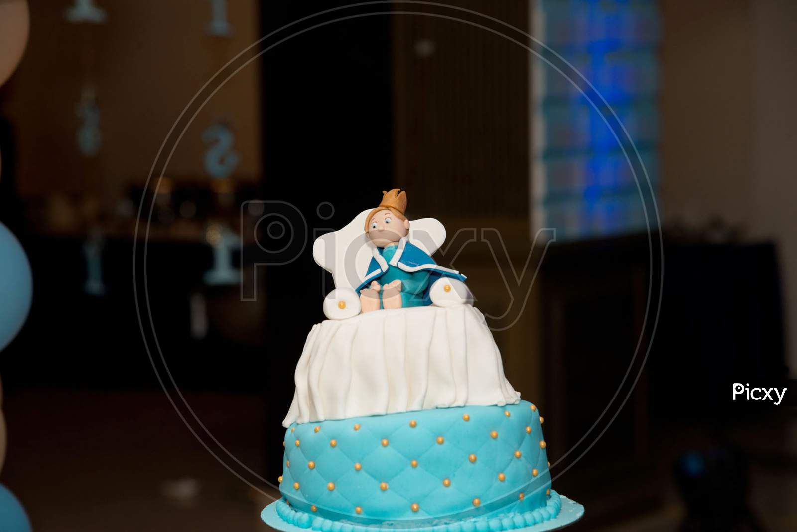 blue birthday cake with doll character for children party