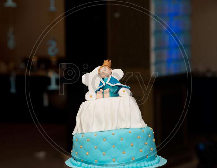 blue birthday cake with doll character for children party
