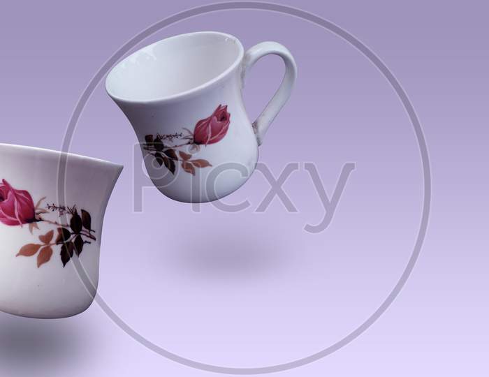 Empty tea or coffee cups isolated image,crockery cup without tea in blueish white color with printed flower design on it