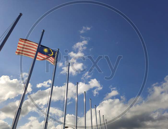 March 15, 2020 - Sabah, Malaysia : Flag of Malaysia flown on flagpole with sky background
