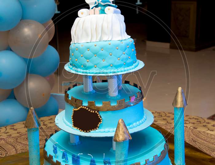 blue castle birthday cake with doll for kids party