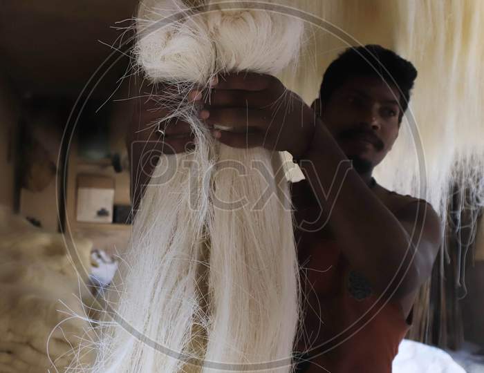 A man carries strands of vermicelli, a specialty ate during the holy month of Ramadan, to dry it at a factory during a nationwide lockdown to slow the spreading of the coronavirus disease (COVID-19), in Prayagraj, April 28, 2020.