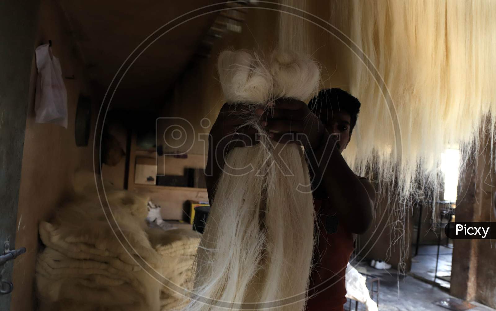 A man carries strands of vermicelli, a specialty ate during the holy month of Ramadan, to dry it at a factory during a nationwide lockdown to slow the spreading of the coronavirus disease (COVID-19), in Prayagraj, April 28, 2020.