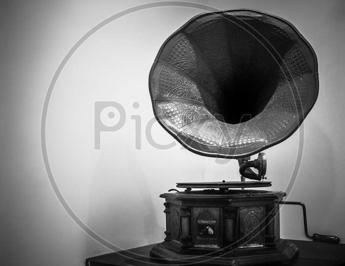Vintage Gramophone On A Wooden With Isolated White Background.