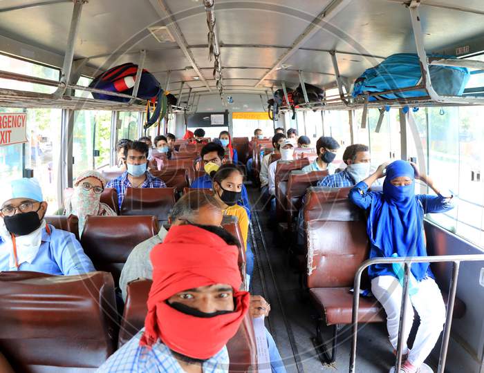 People occupy seats as they board a bus to reach their hometown as arranged by the Uttar Pradesh government as a preventive measure against the covid-19 in addition to the government imposed nationwide lockdown, in Prayagraj April 28, 2020.