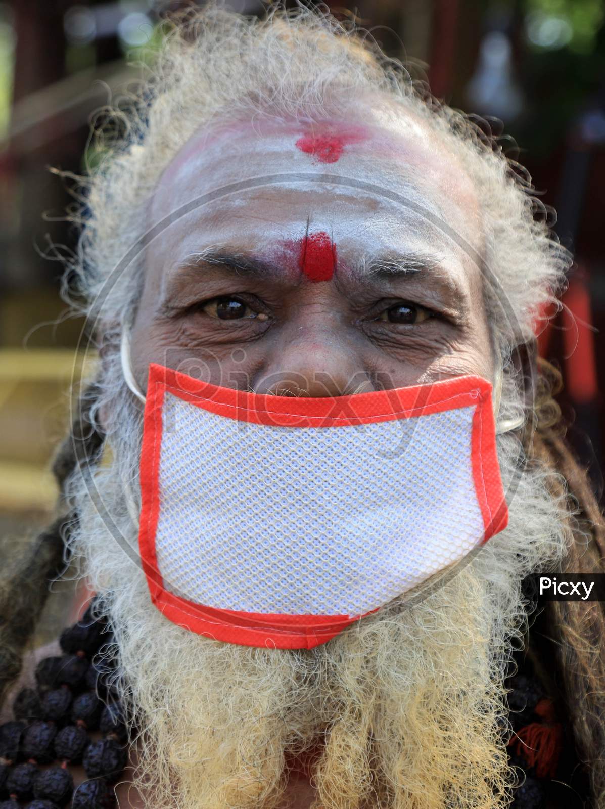 A sadhu wears a face mask to spread awareness among people against COVID-19 during government imposed nationwide lockdown as a preventive measure against the COVID-19 coronavirus in Prayagraj, April 28, 2020.