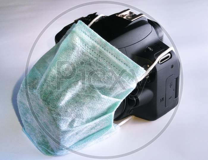 camera with a mask on a white backdrop