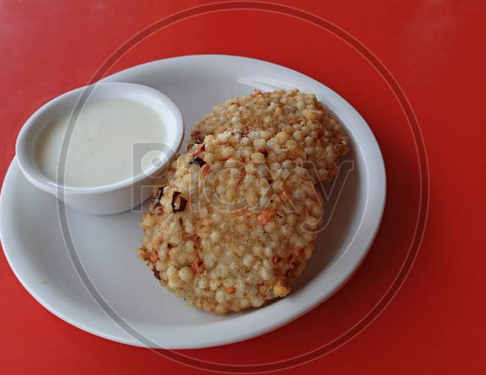 Sabudana vada with curds tasty indian snack, also known as Tapioca pearls.