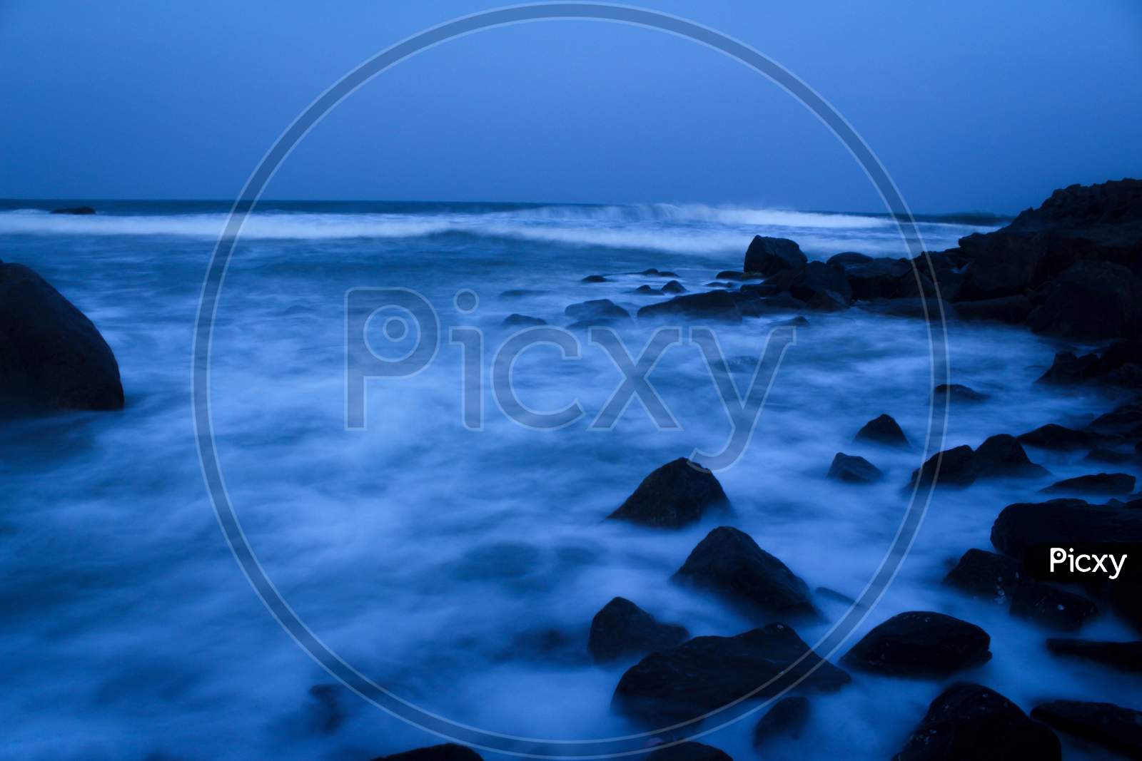 Seascape Beach Waves With Rocks On Long Exposure At Mahabalipuram Beach. Motion Blur Photography.