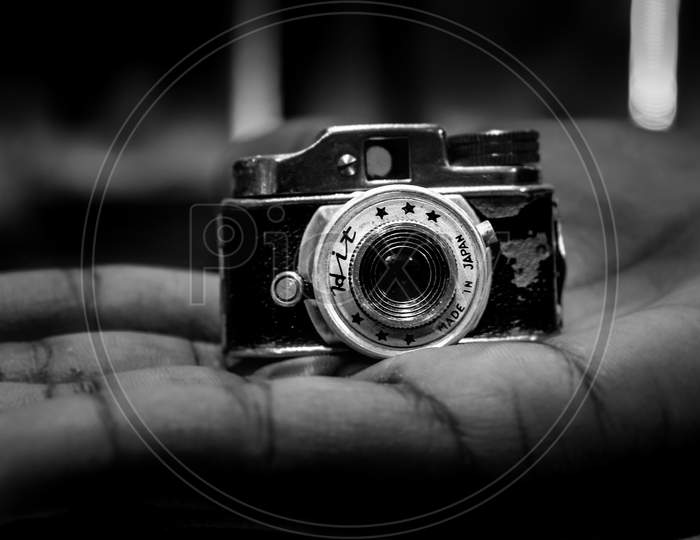 Vintage Mini Camera Holding On Hand. Mini Vintage Hidden Camera