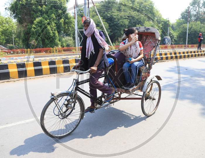 A girl takes a rikshaw ride in Prayagraj to board a bus to reach her hometown as arranged by the Uttar Pradesh government as a preventive measure against the COVID-19 in addition to the government imposed nationwide lockdown, April 28, 2020.